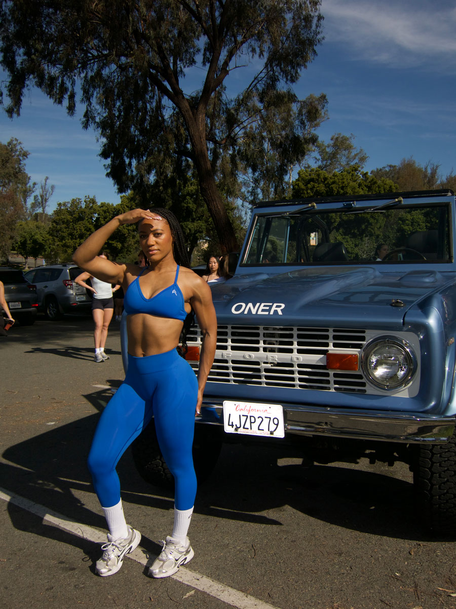 The coach is posing while wearing blue clothing.